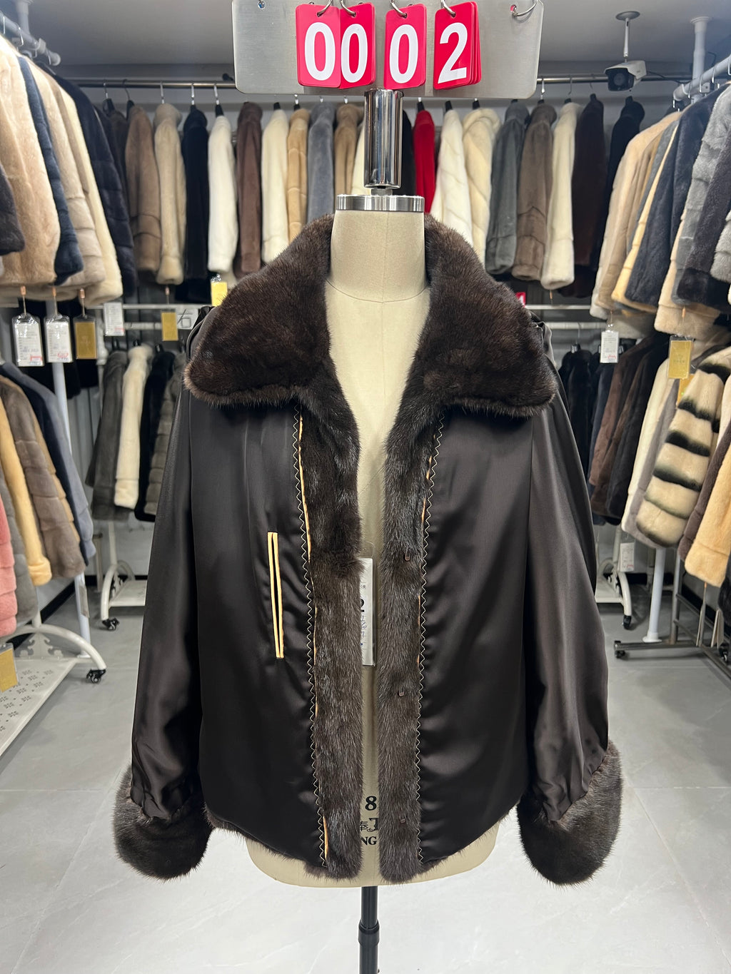 Brown mink coat with a shawl collar and turn-up cuffs.002