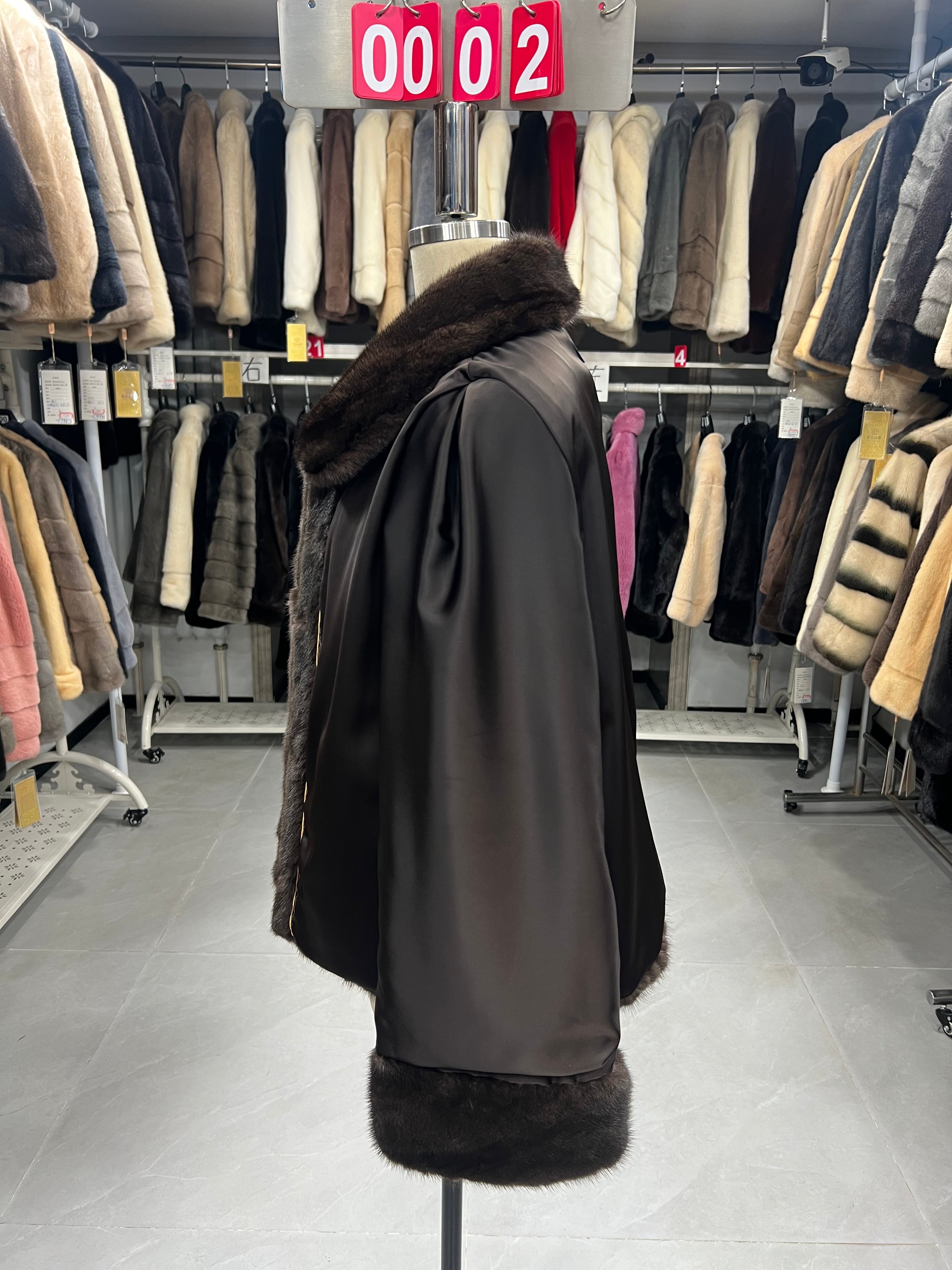 Brown mink coat with a shawl collar and turn-up cuffs.002