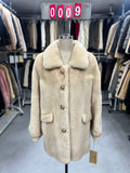 Beige velvet-finish mink coat featuring a lapel collar, horizontal pocket flaps, and vintage-style button detailing.009