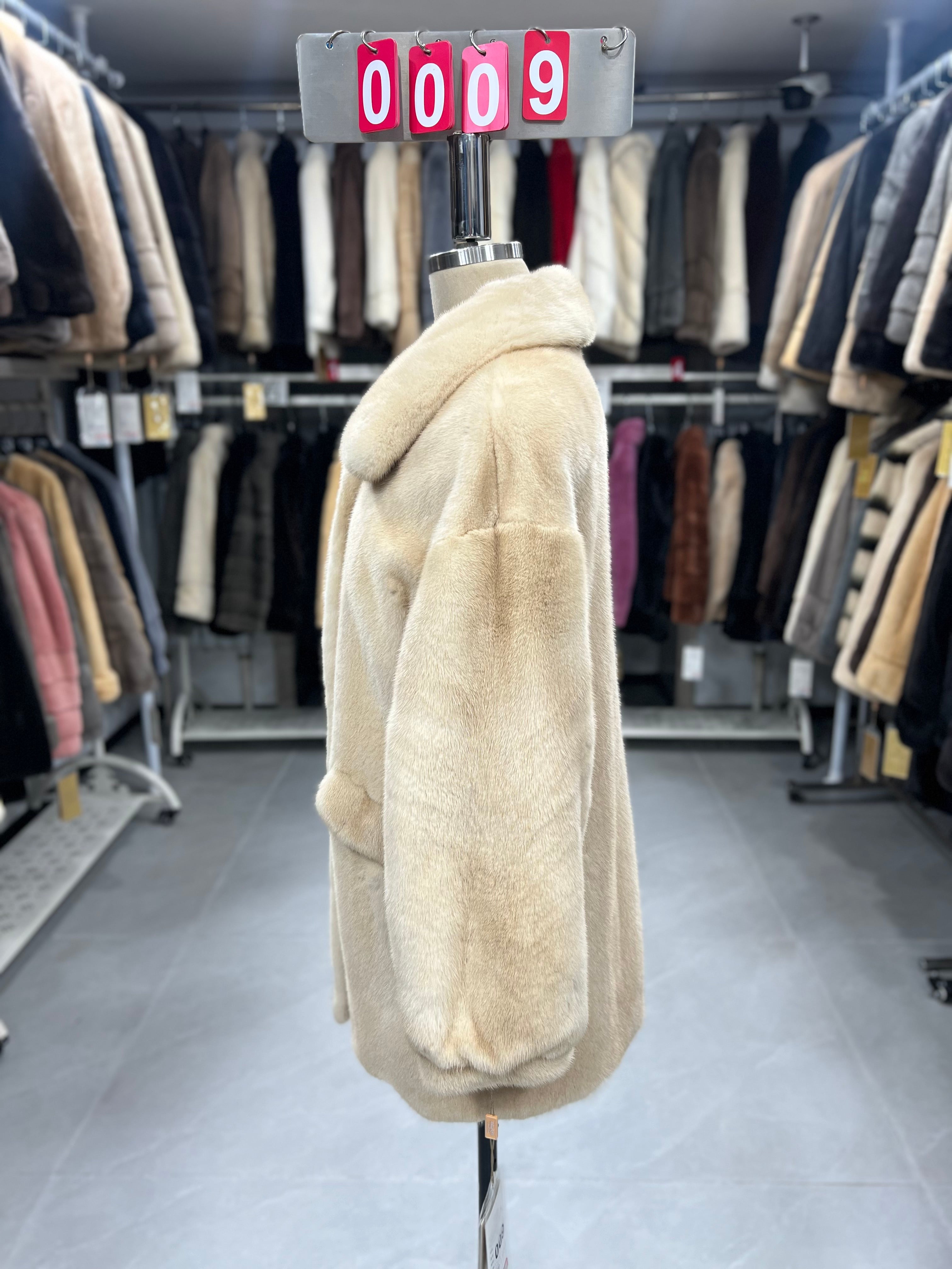 Beige velvet-finish mink coat featuring a lapel collar, horizontal pocket flaps, and vintage-style button detailing.009