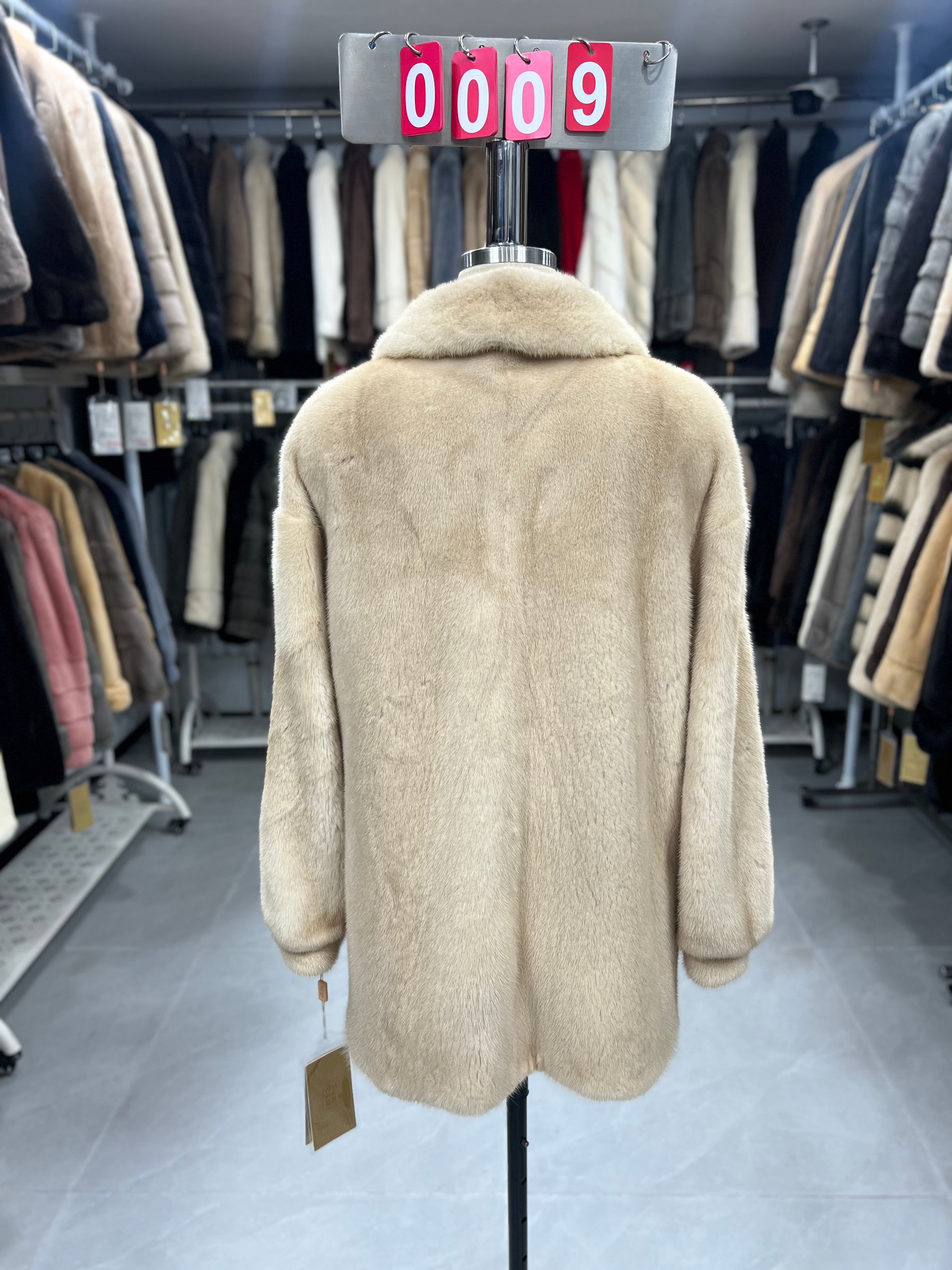 Beige velvet-finish mink coat featuring a lapel collar, horizontal pocket flaps, and vintage-style button detailing.009