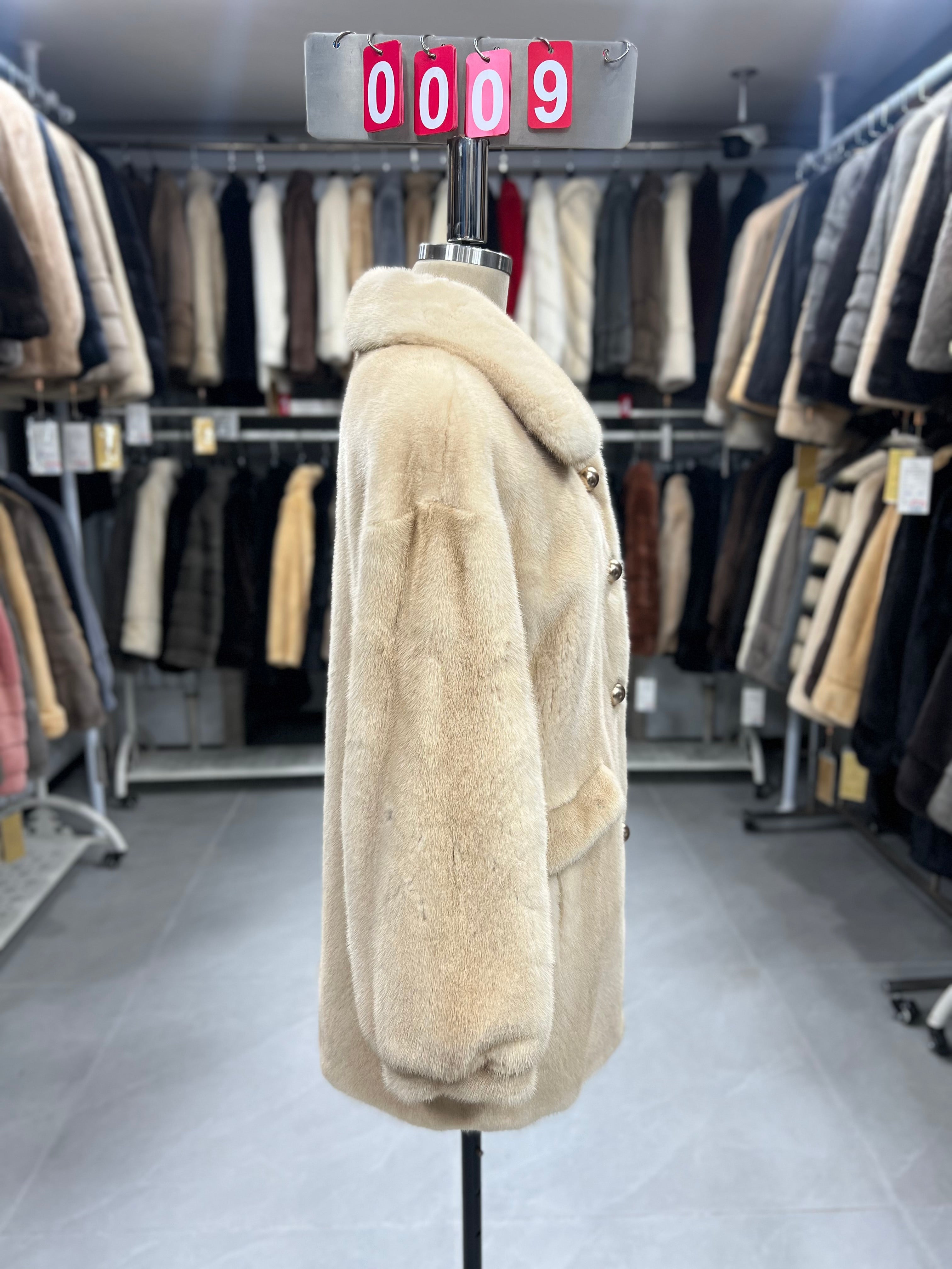 Beige velvet-finish mink coat featuring a lapel collar, horizontal pocket flaps, and vintage-style button detailing.009