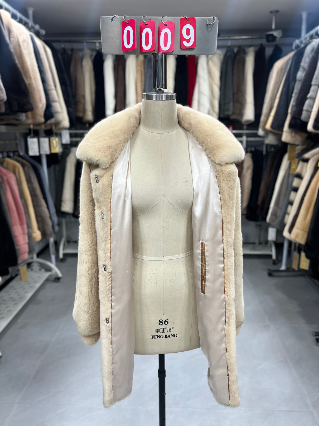 Beige velvet-finish mink coat featuring a lapel collar, horizontal pocket flaps, and vintage-style button detailing.009