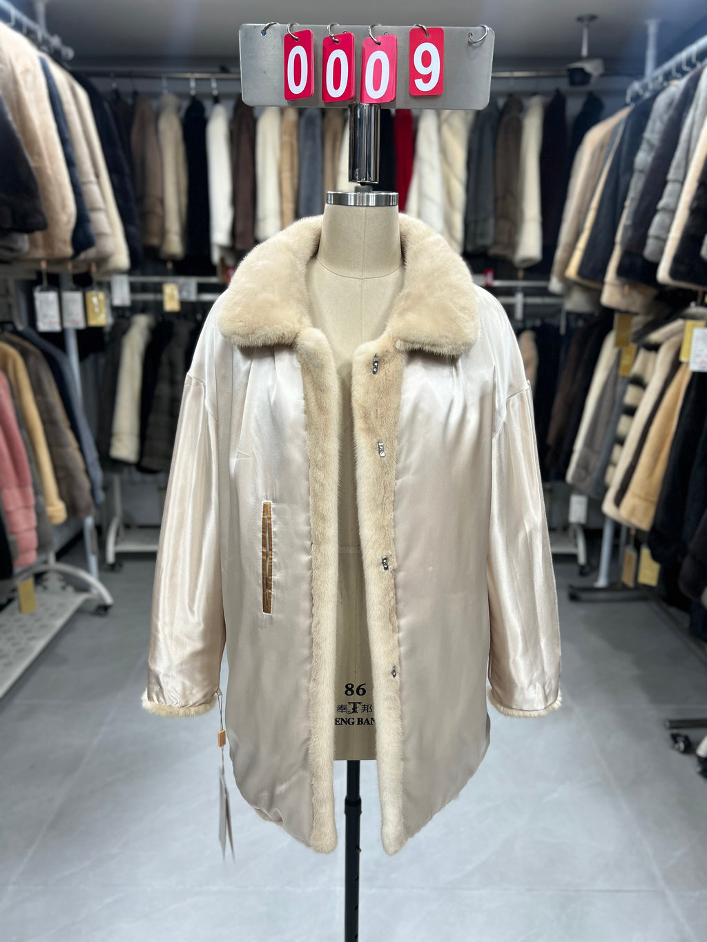 Beige velvet-finish mink coat featuring a lapel collar, horizontal pocket flaps, and vintage-style button detailing.009