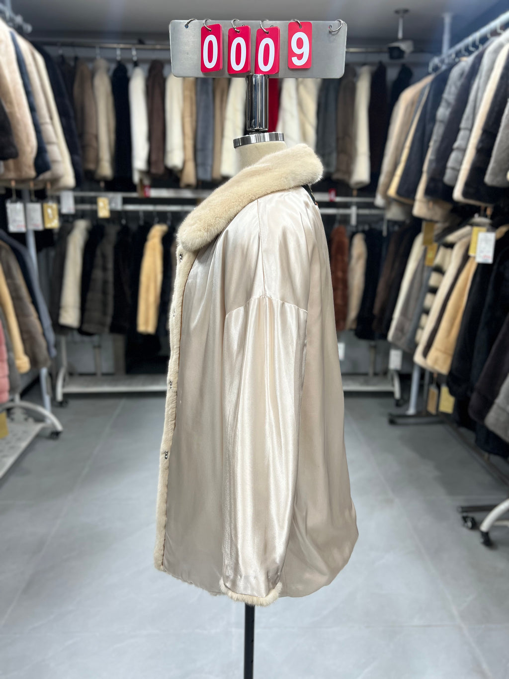 Beige velvet-finish mink coat featuring a lapel collar, horizontal pocket flaps, and vintage-style button detailing.009