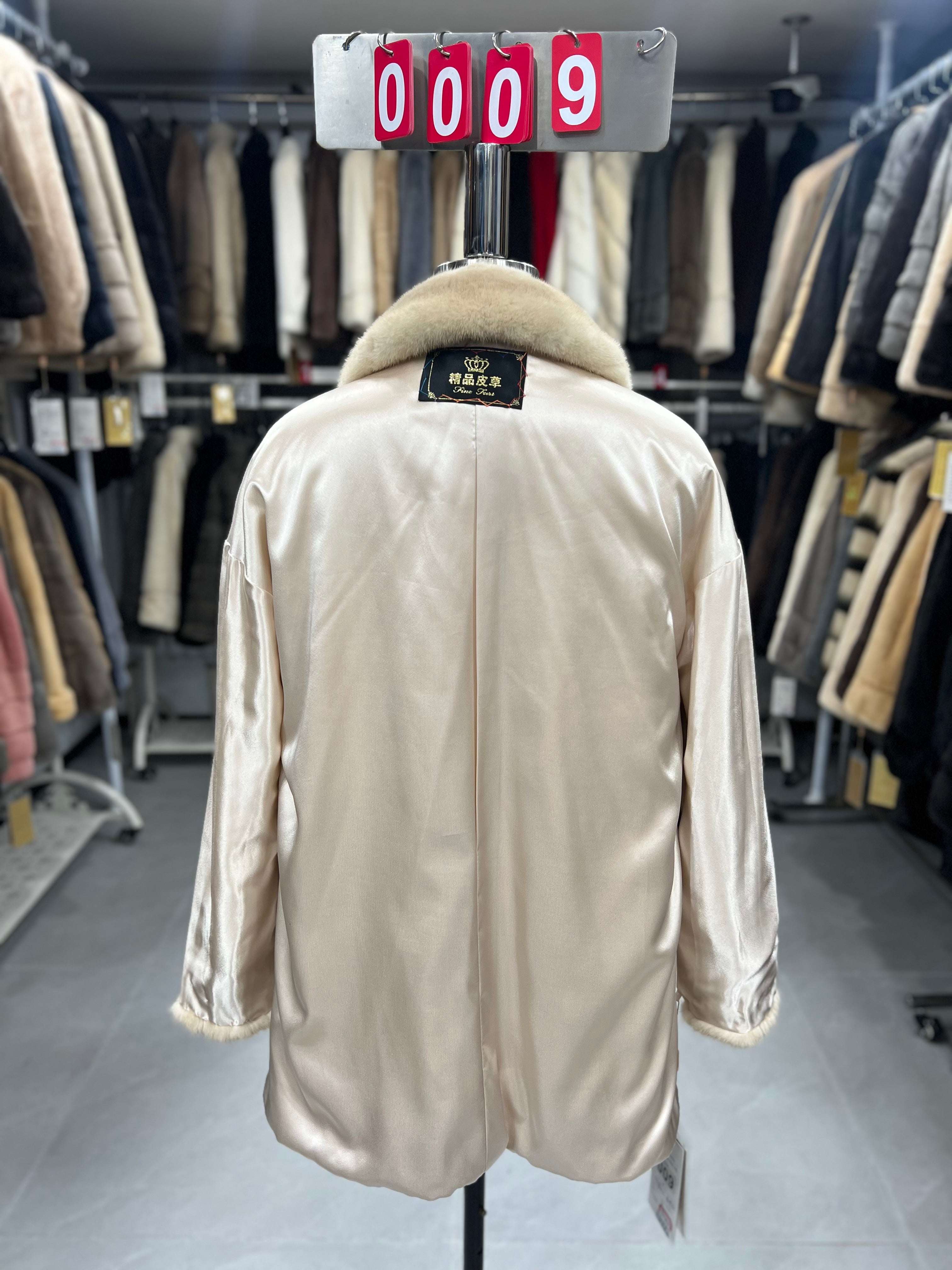 Beige velvet-finish mink coat featuring a lapel collar, horizontal pocket flaps, and vintage-style button detailing.009