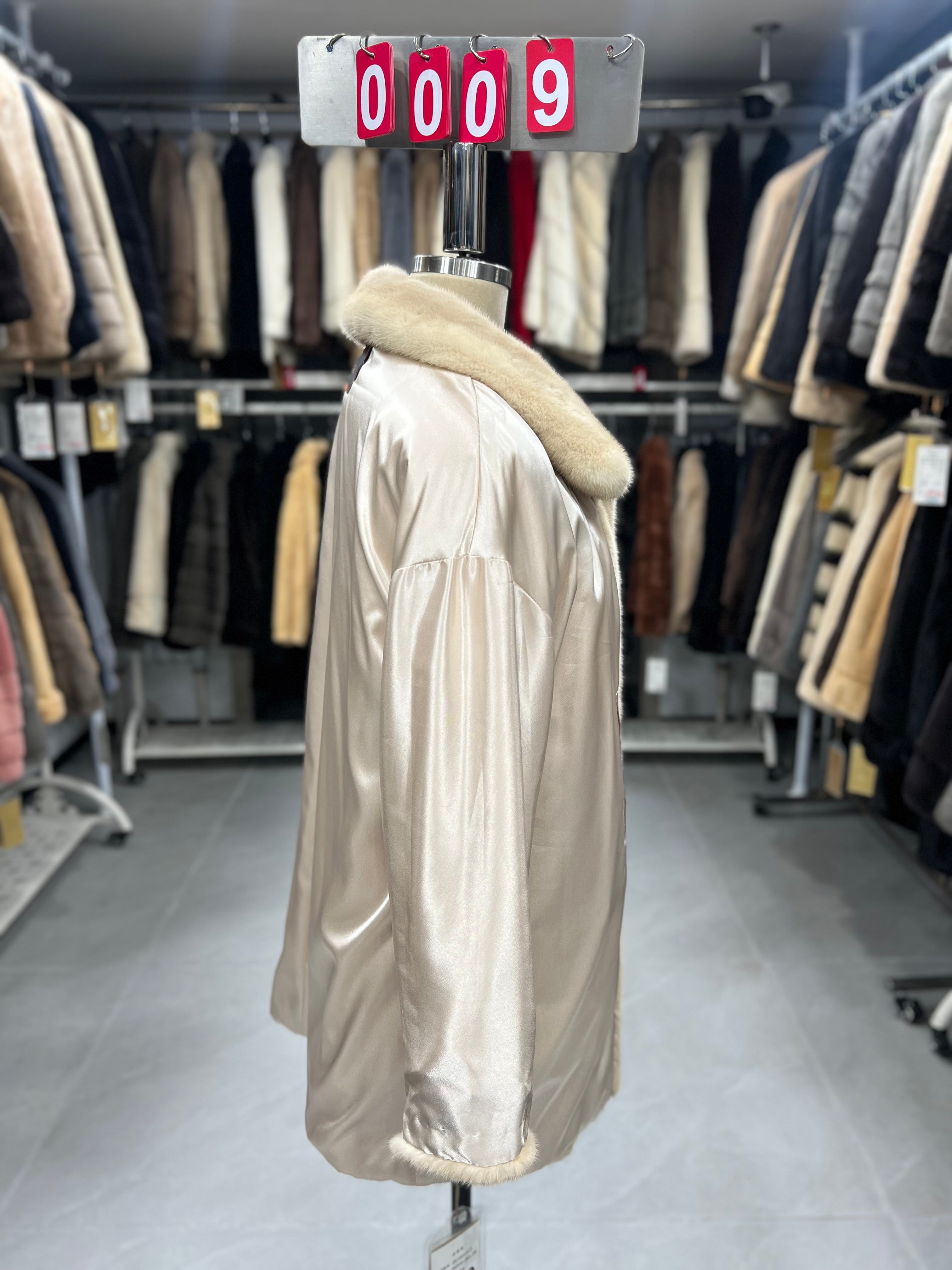 Beige velvet-finish mink coat featuring a lapel collar, horizontal pocket flaps, and vintage-style button detailing.009