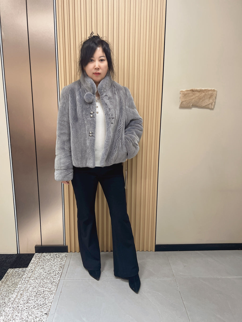 No. 162: Grey mink fur coat with a stand-up collar and pom-pom embellishments at the neckline.