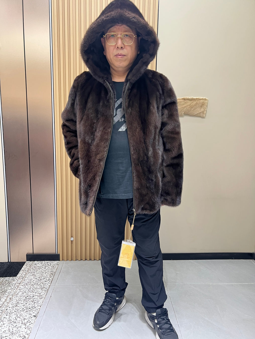 No. 126 Men's dark brown hooded mink coat with front zip closure.