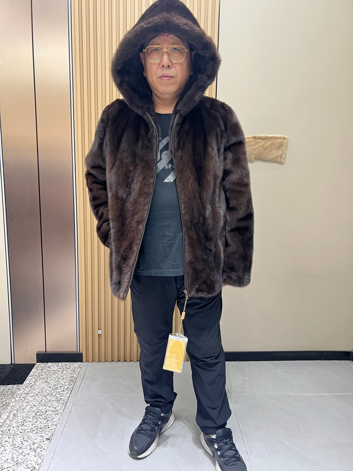 No. 126 Men's dark brown hooded mink coat with front zip closure.