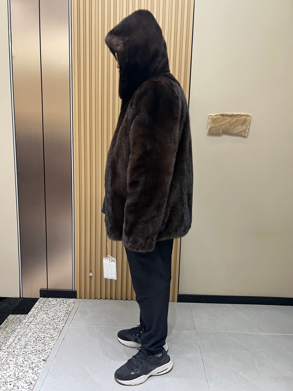 No. 126 Men's dark brown hooded mink coat with front zip closure.