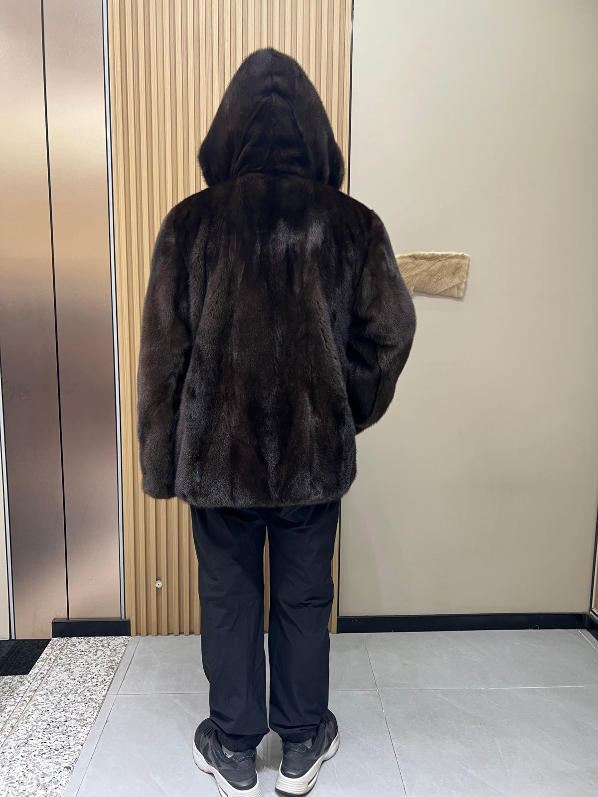 No. 126 Men's dark brown hooded mink coat with front zip closure.