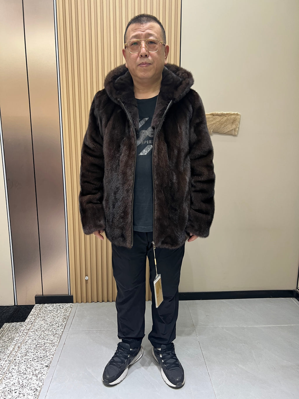 No. 126 Men's dark brown hooded mink coat with front zip closure.