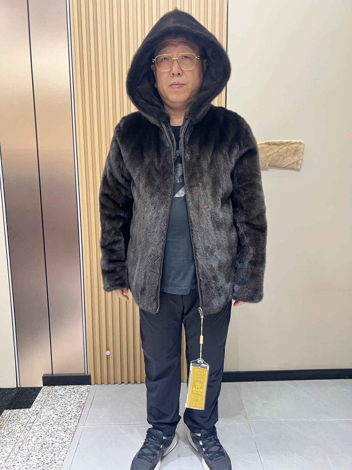 No. 127 Men's dark brown hooded mink coat with front zip closure.