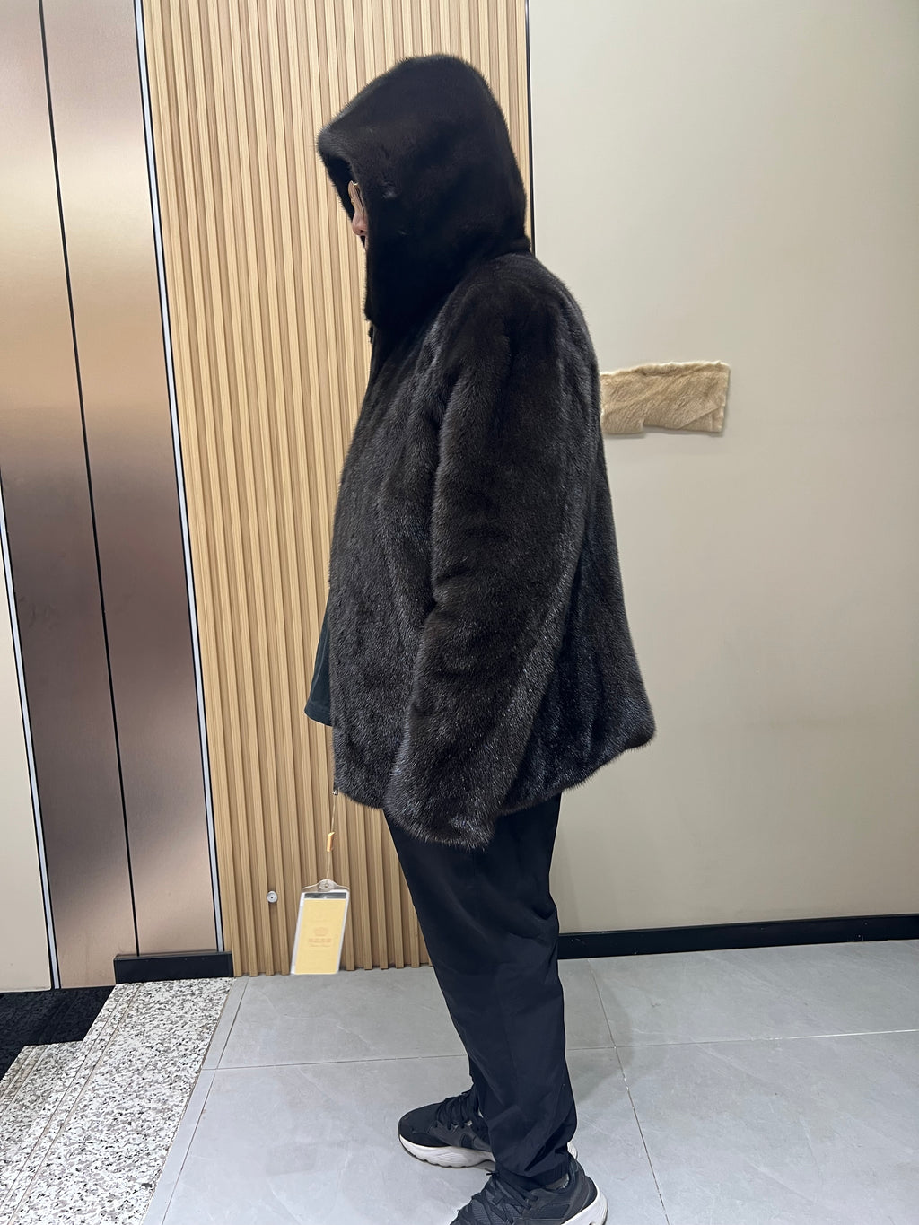 No. 127 Men's dark brown hooded mink coat with front zip closure.