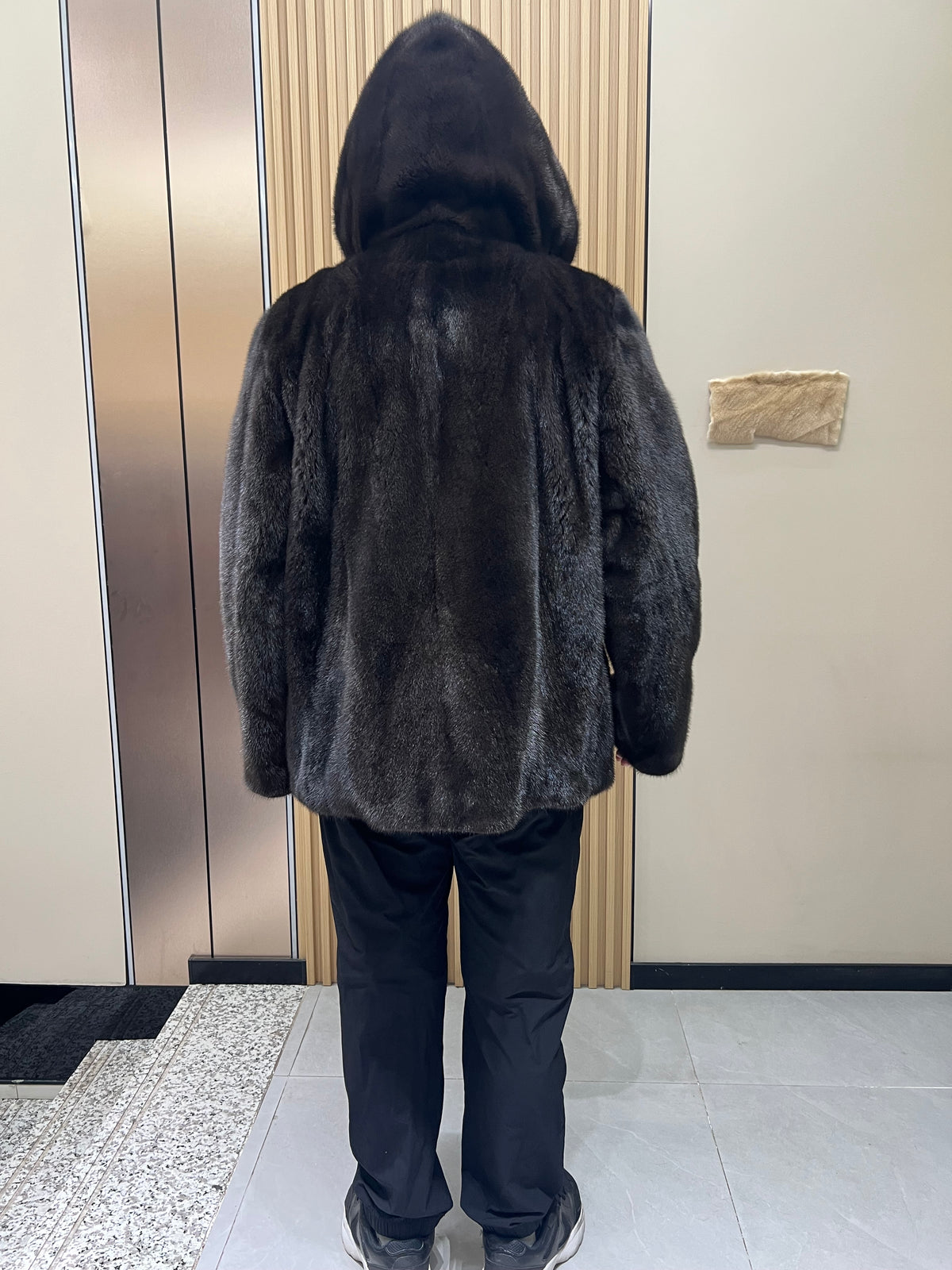 No. 127 Men's dark brown hooded mink coat with front zip closure.