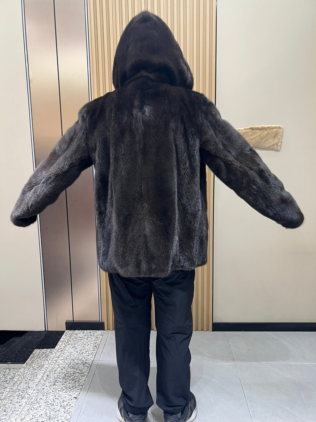 No. 127 Men's dark brown hooded mink coat with front zip closure.