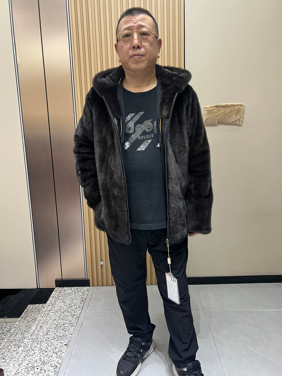 No. 127 Men's dark brown hooded mink coat with front zip closure.
