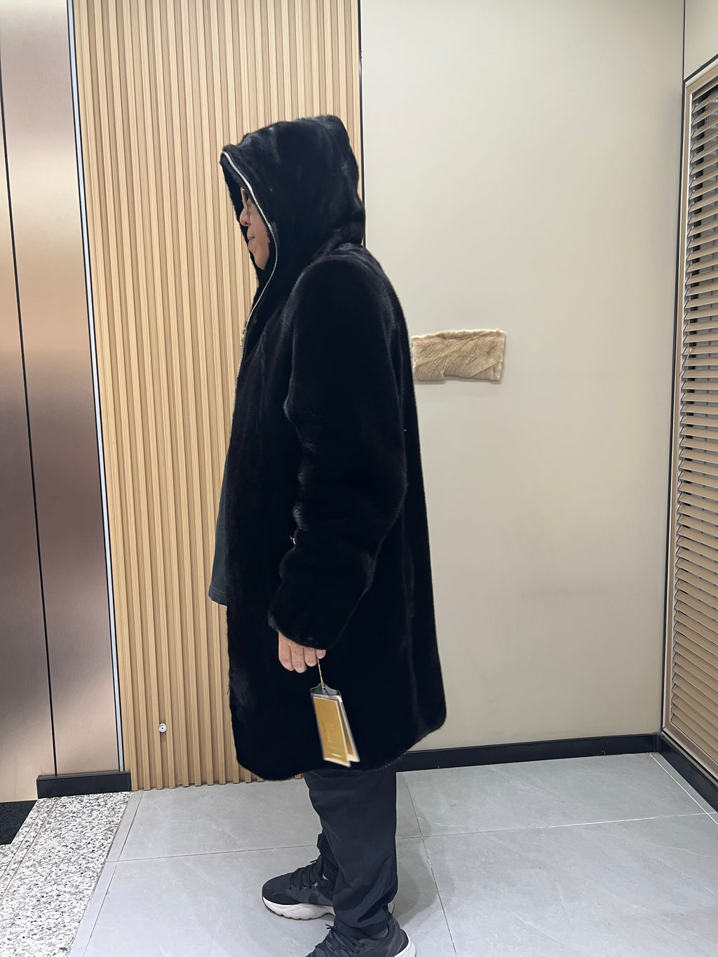No. 128 Men's black long-length hooded mink coat with front zip closure.