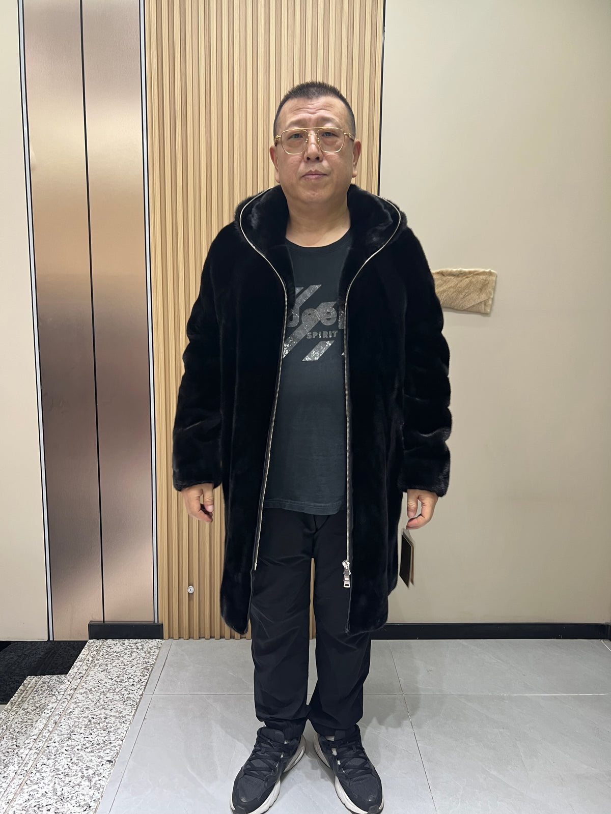 No. 128 Men's black long-length hooded mink coat with front zip closure.
