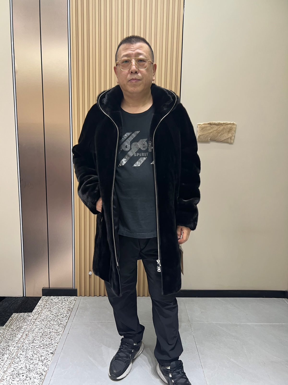 No. 128 Men's black long-length hooded mink coat with front zip closure.