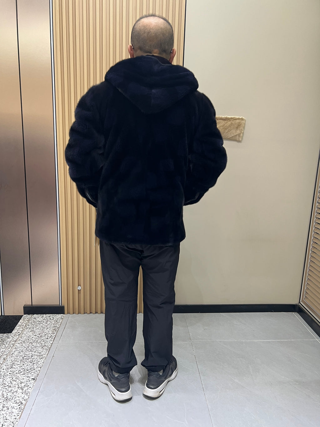 No. 129 Men's dark blue hooded mink coat with front zip closure.