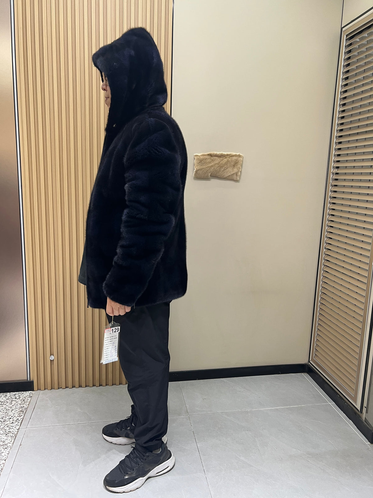 No. 129 Men's dark blue hooded mink coat with front zip closure.