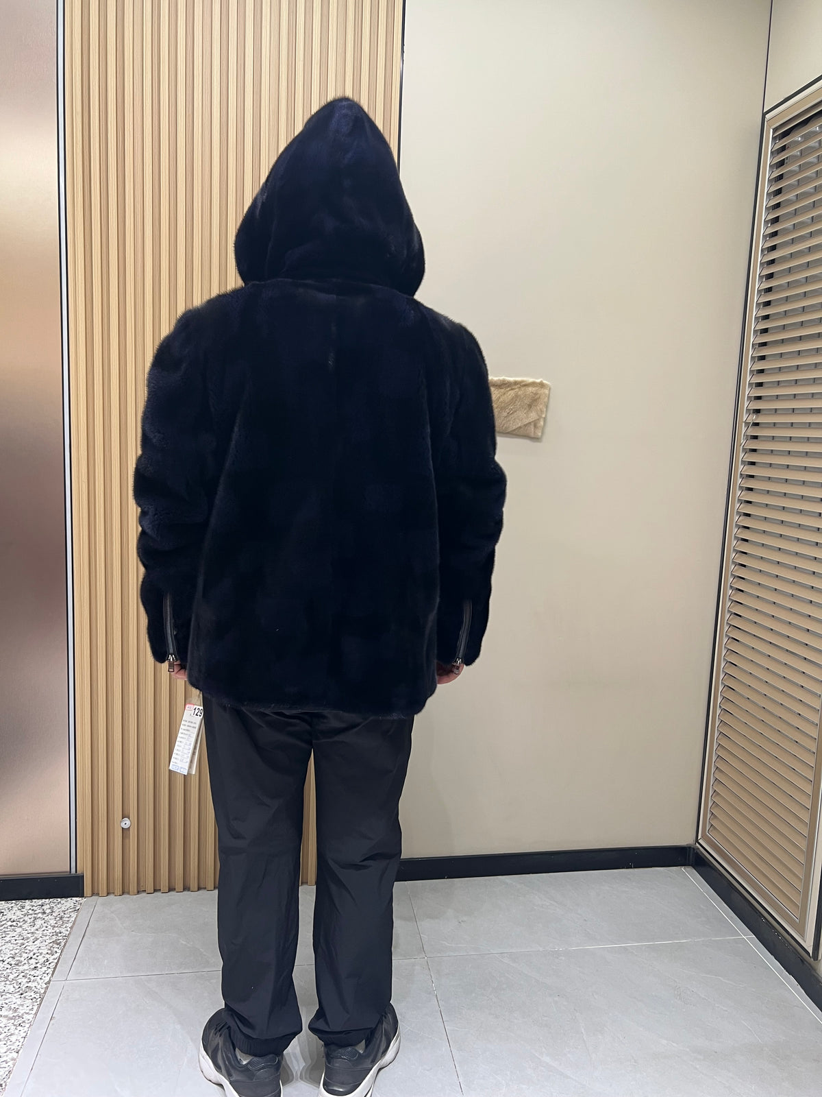 No. 129 Men's dark blue hooded mink coat with front zip closure.
