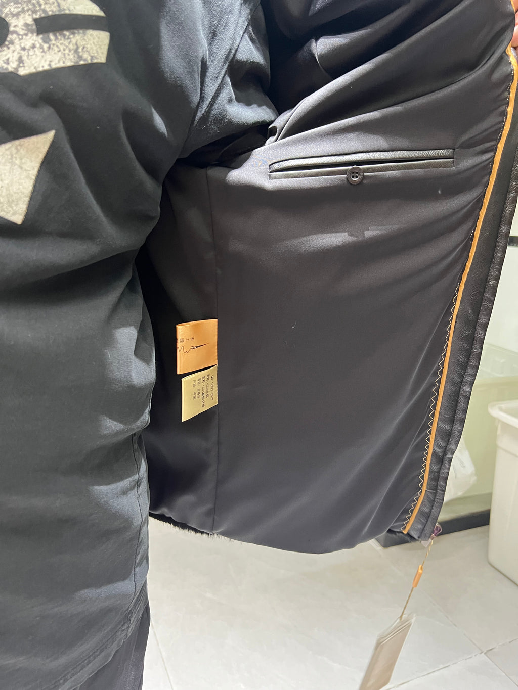 No. 130 Men's black mink coat featuring a lapel collar and zip closure.
