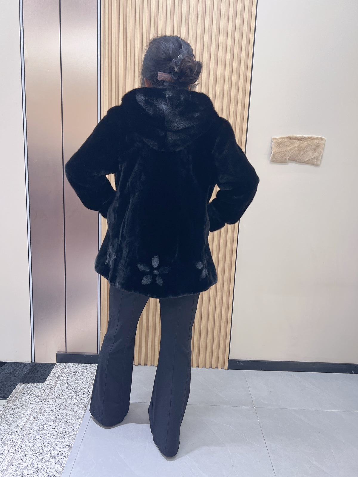 No. 194 black hooded mink fur coat, featuring a petal-shaped hem design.