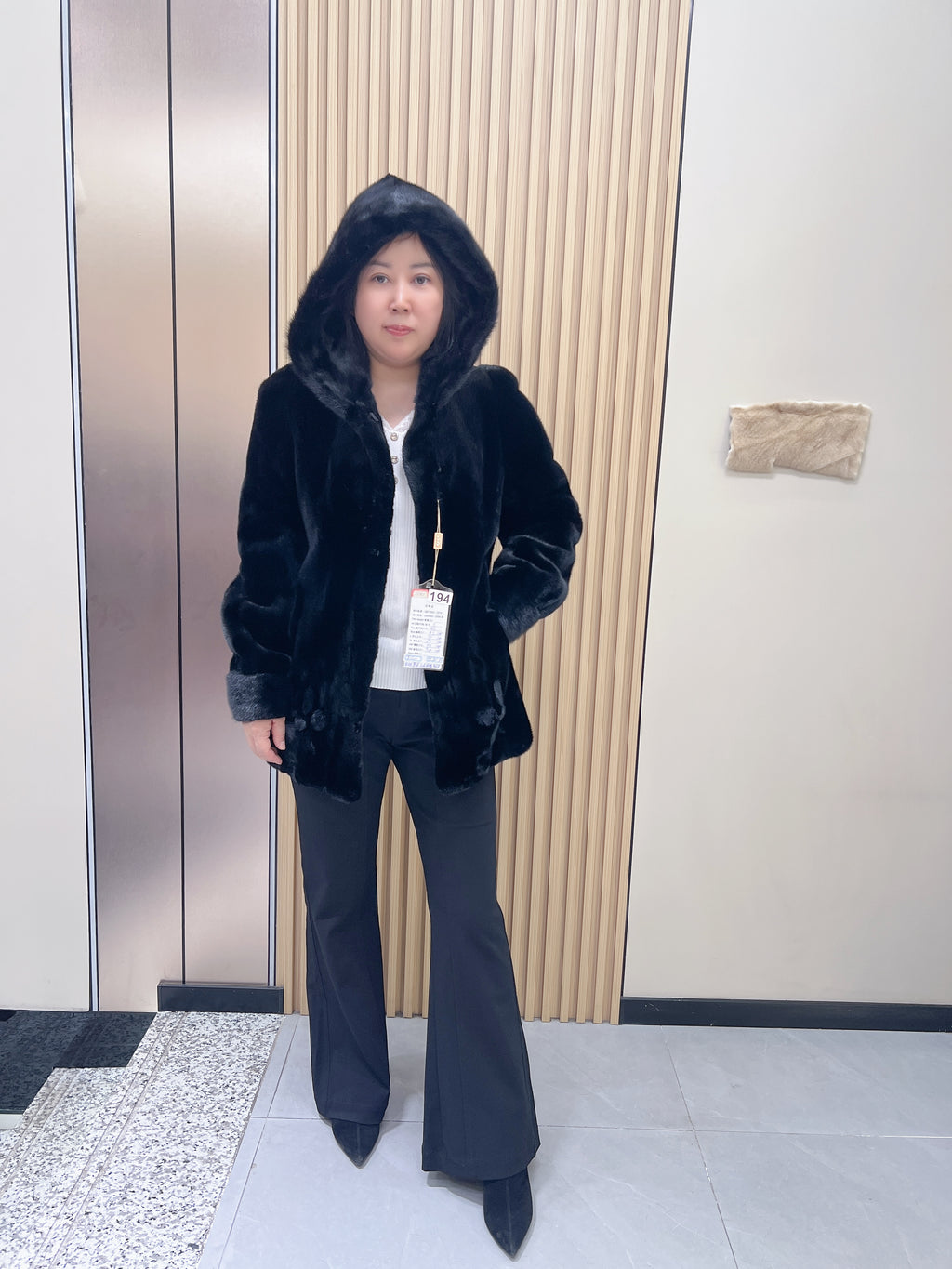 No. 194 black hooded mink fur coat, featuring a petal-shaped hem design.
