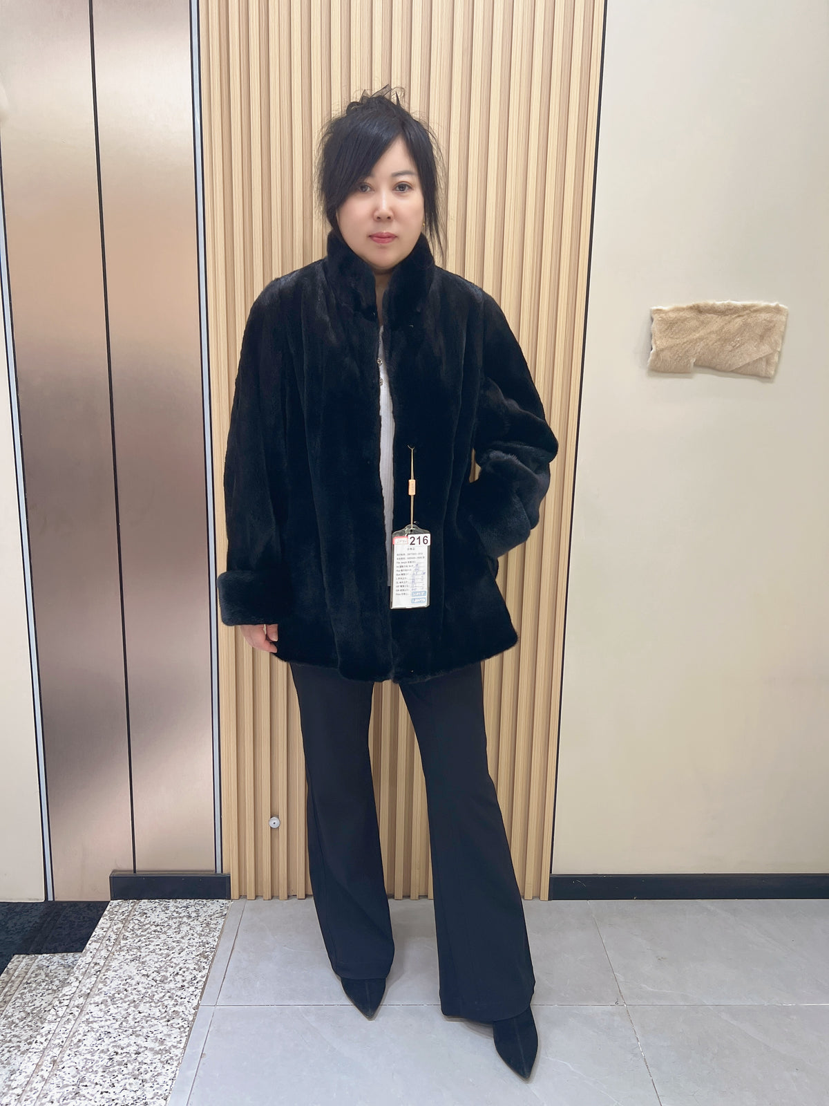 No. 216 black mink fur coat, featuring a stand collar and turn-back cuffs.