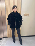 No. 225 black mink fur coat with a stand-up collar and vintage-style bronze-tone buttons.