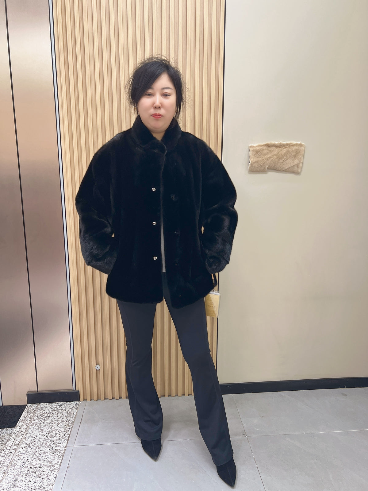 No. 225 black mink fur coat with a stand-up collar and vintage-style bronze-tone buttons.