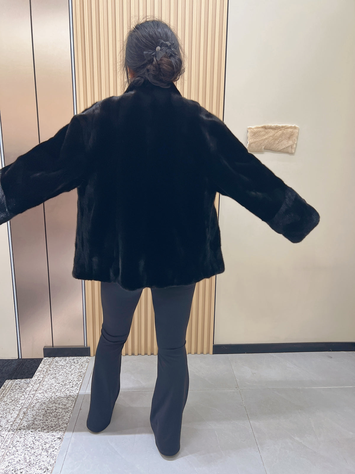 No. 225 black mink fur coat with a stand-up collar and vintage-style bronze-tone buttons.