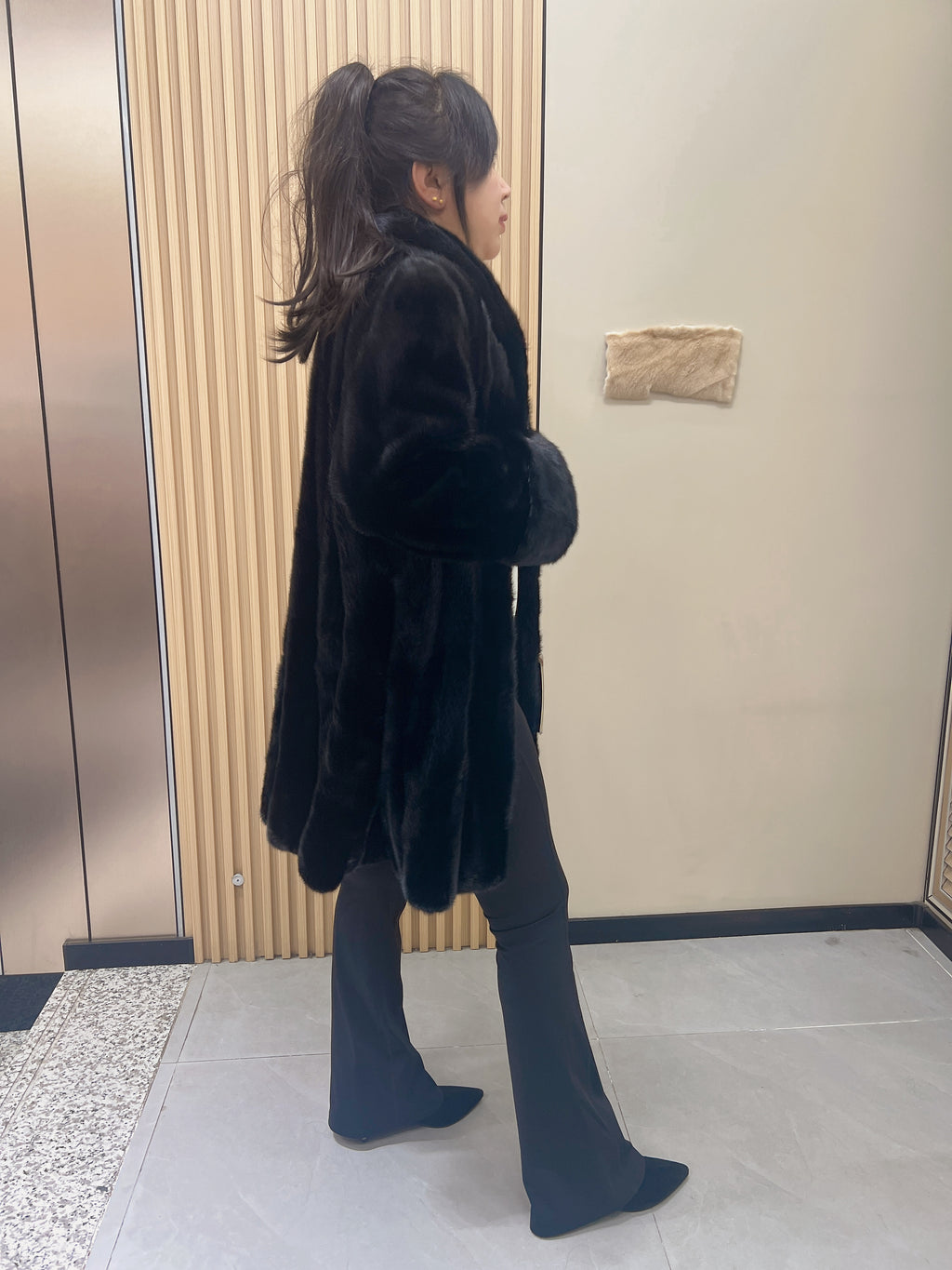 No. 209 black mink coat, mid-length, featuring a stand collar and turn-back cuffs.