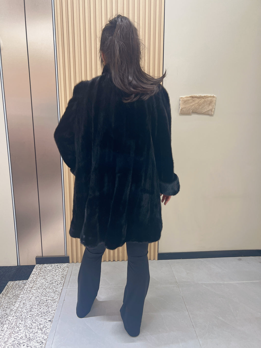 No. 209 black mink coat, mid-length, featuring a stand collar and turn-back cuffs.