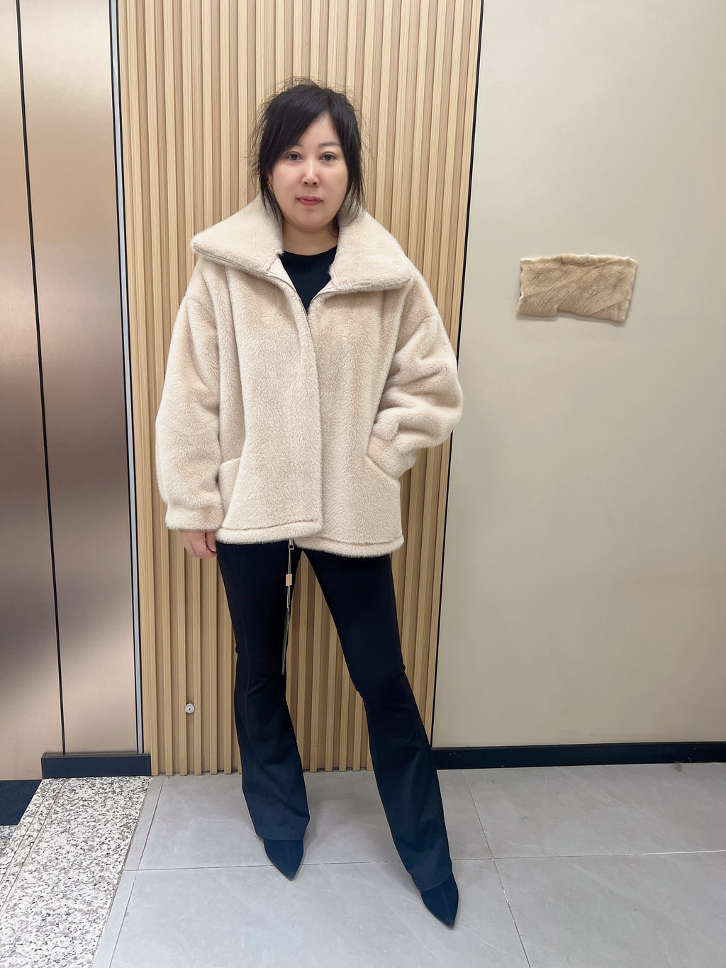 No. 279 Beige faux-fur jacket with a lapel collar and zip fastening.