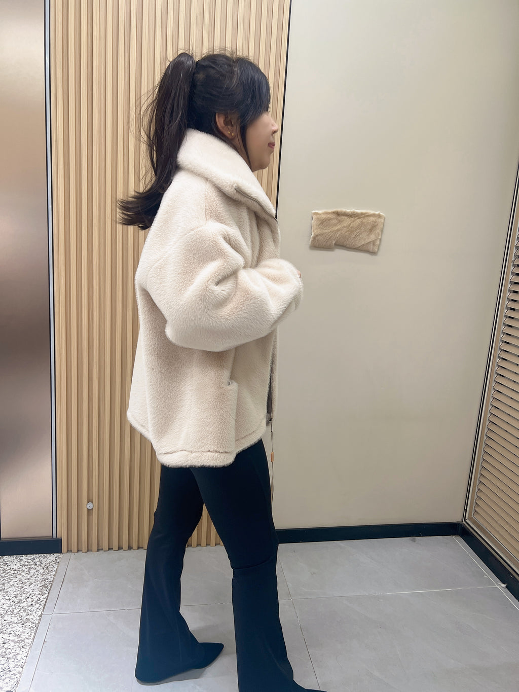 No. 279 Beige faux-fur jacket with a lapel collar and zip fastening.