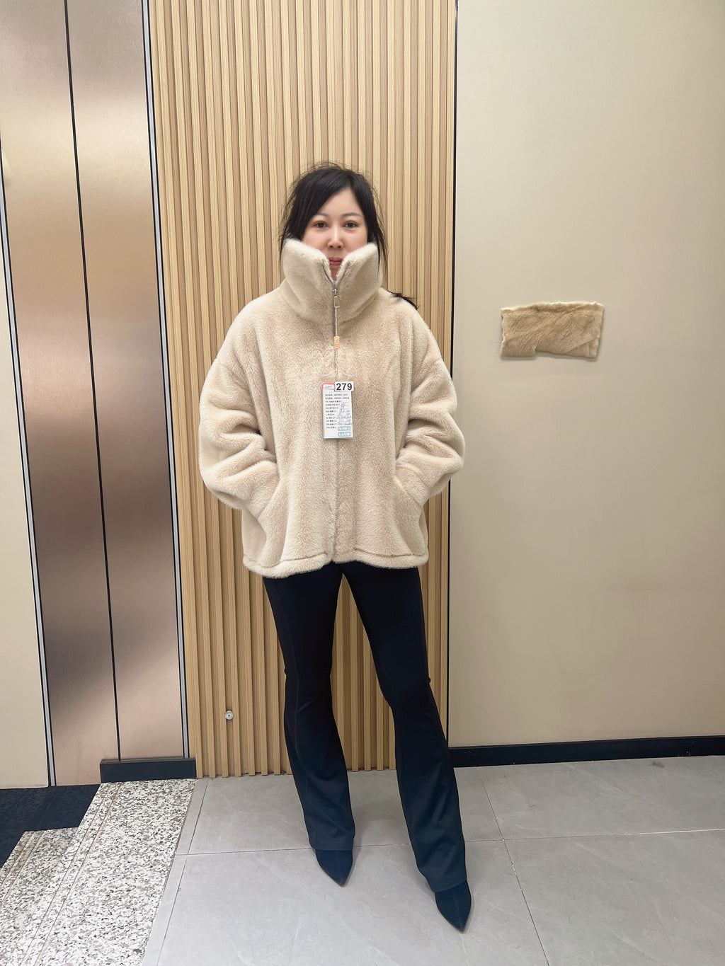 No. 279 Beige faux-fur jacket with a lapel collar and zip fastening.