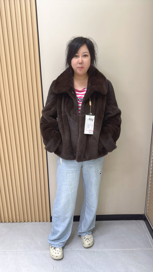 002 Brown mink coat with a shawl collar and turn-up cuffs.