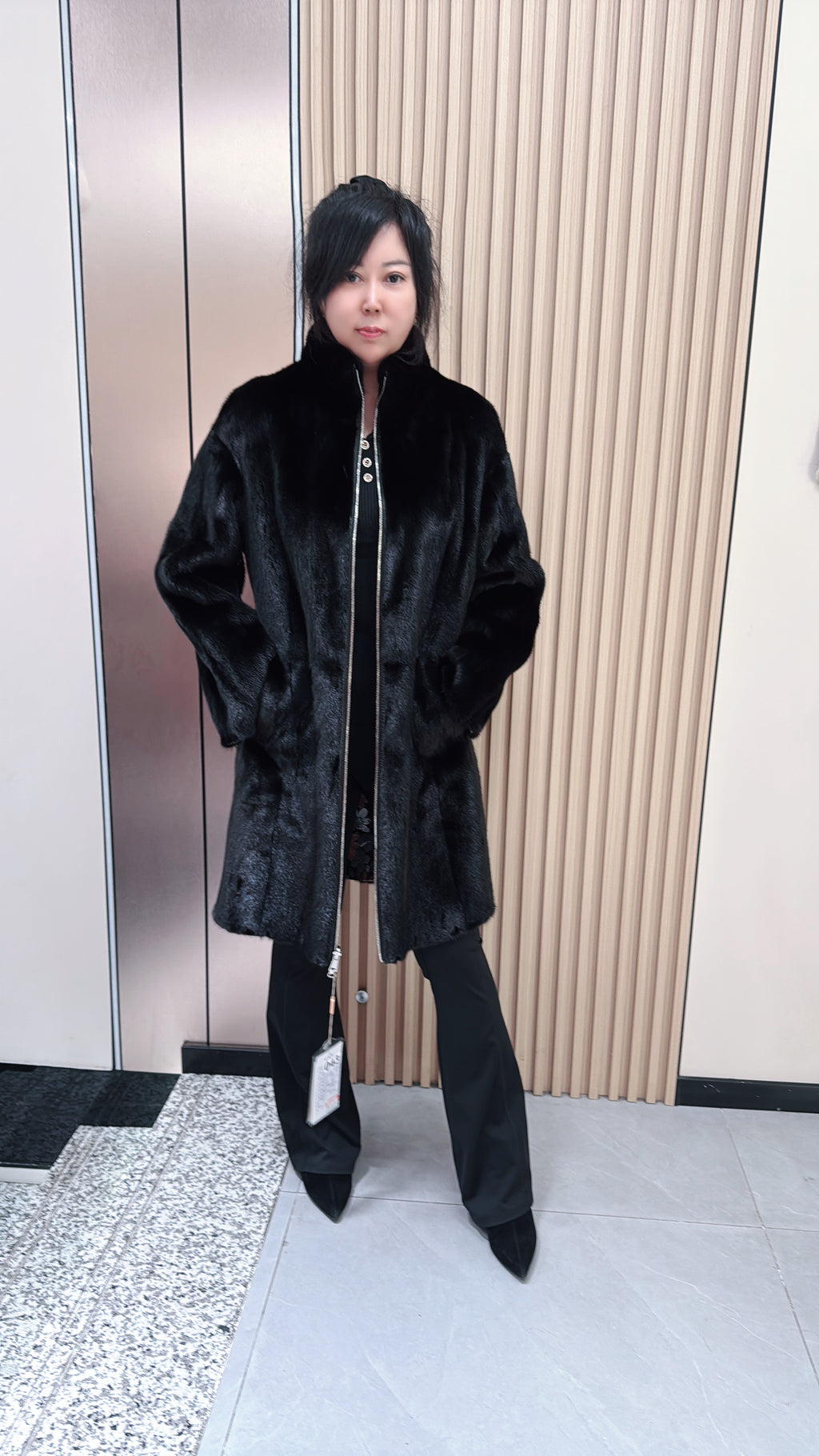 No. 043 Black reversible mink fur coat featuring a stand collar and zip closure.