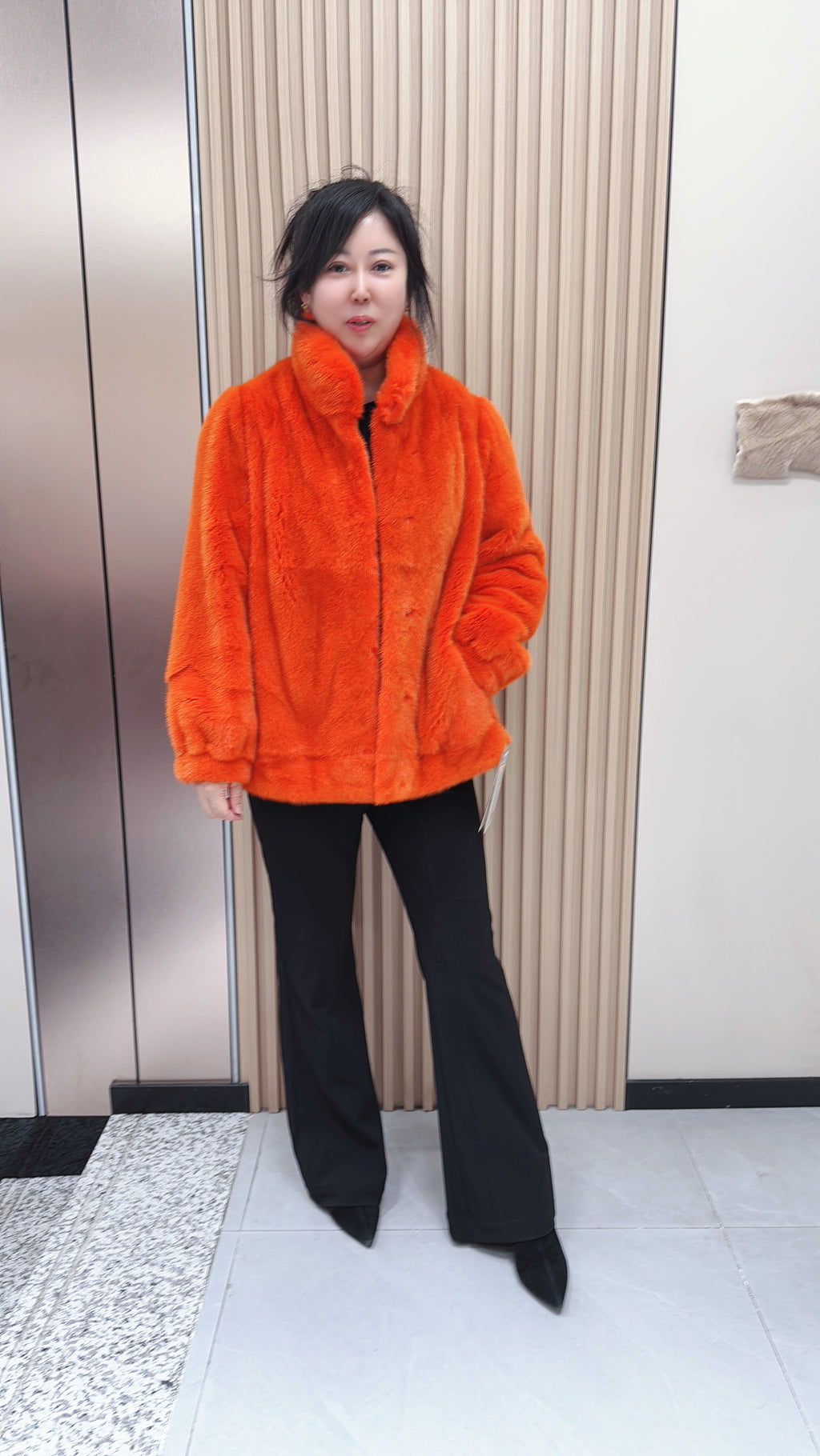 No. 095 Orange mink fur coat featuring a stand-up collar and banded cuffs.
