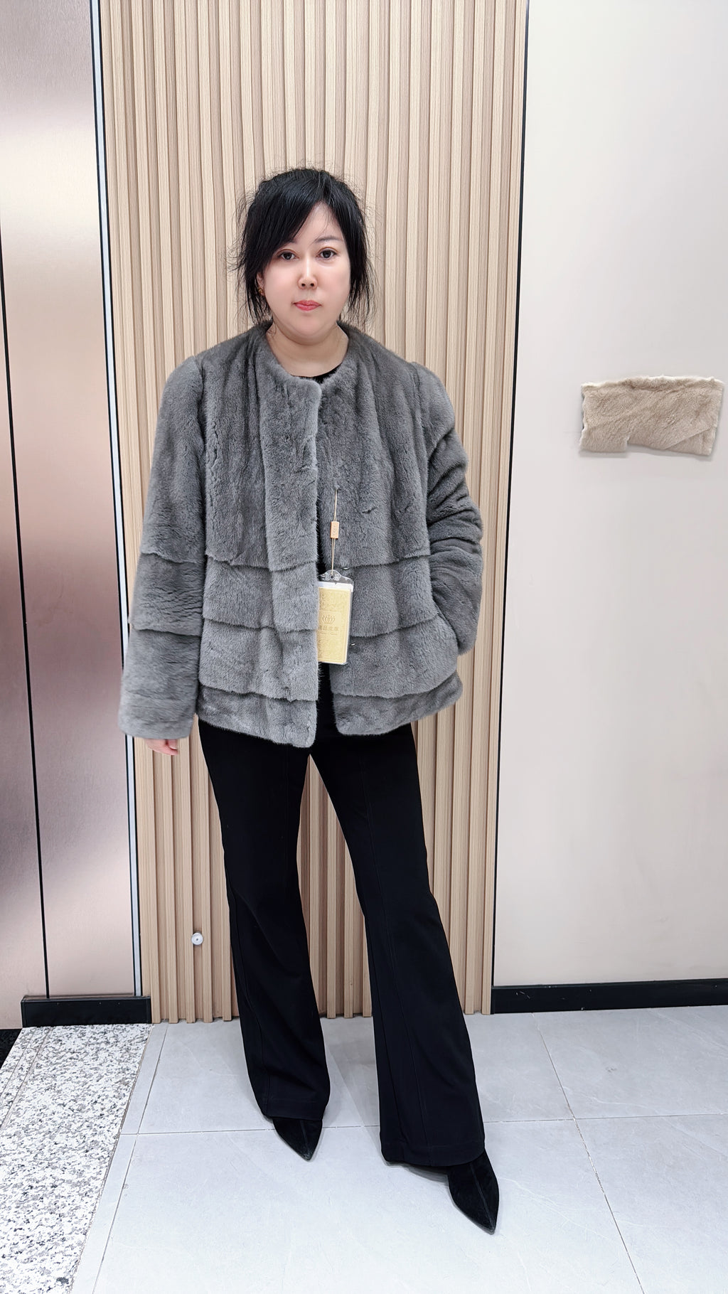 No. 140 Grey mink fur coat featuring a collarless design and a spliced "A/B" panel construction.