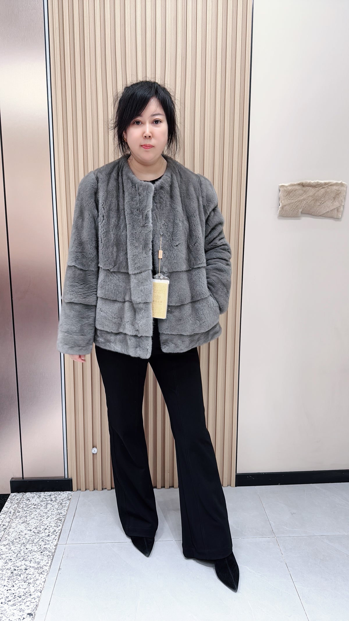 No. 140 Grey mink fur coat featuring a collarless design and a spliced "A/B" panel construction.
