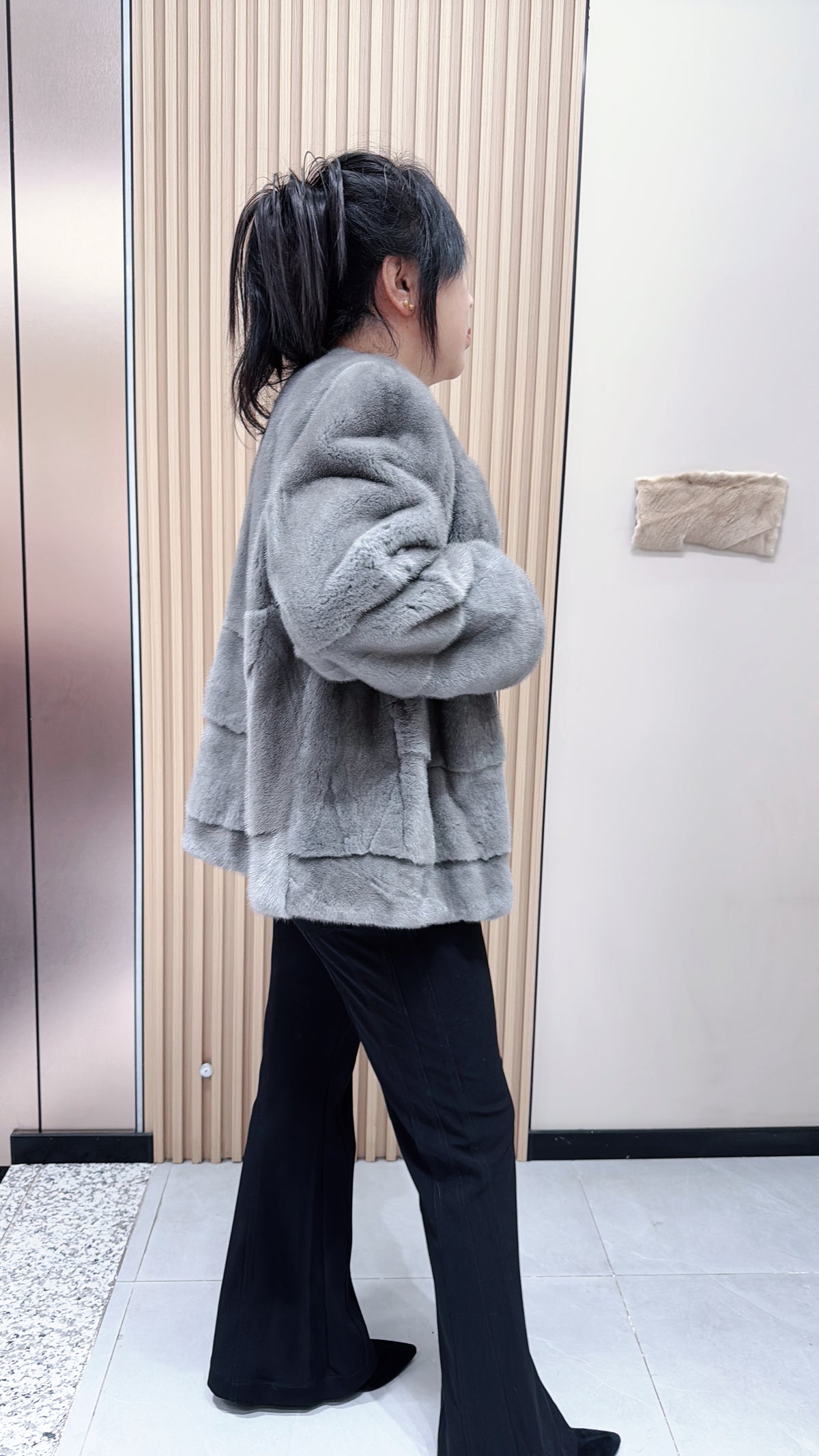 No. 140 Grey mink fur coat featuring a collarless design and a spliced "A/B" panel construction.
