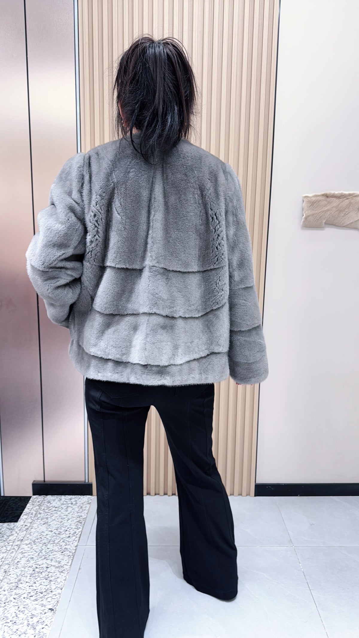 No. 140 Grey mink fur coat featuring a collarless design and a spliced "A/B" panel construction.