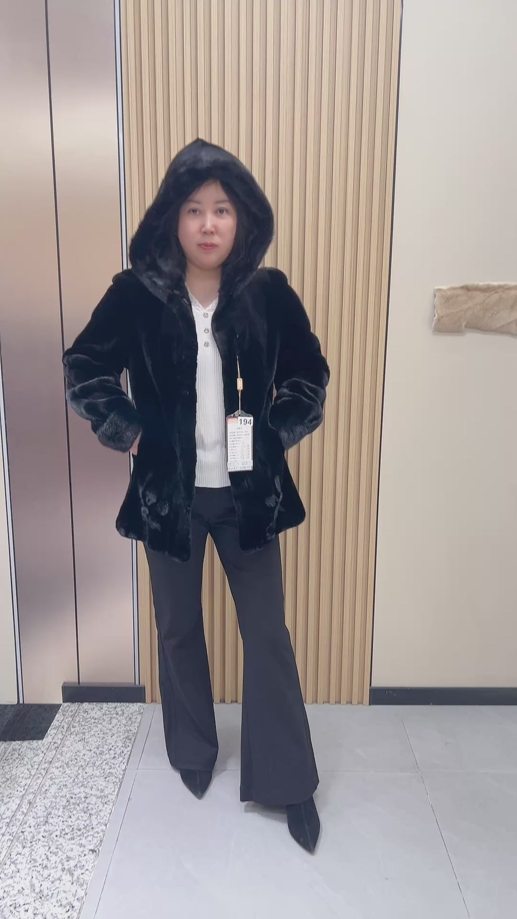 No. 194 black hooded mink fur coat, featuring a petal-shaped hem design.