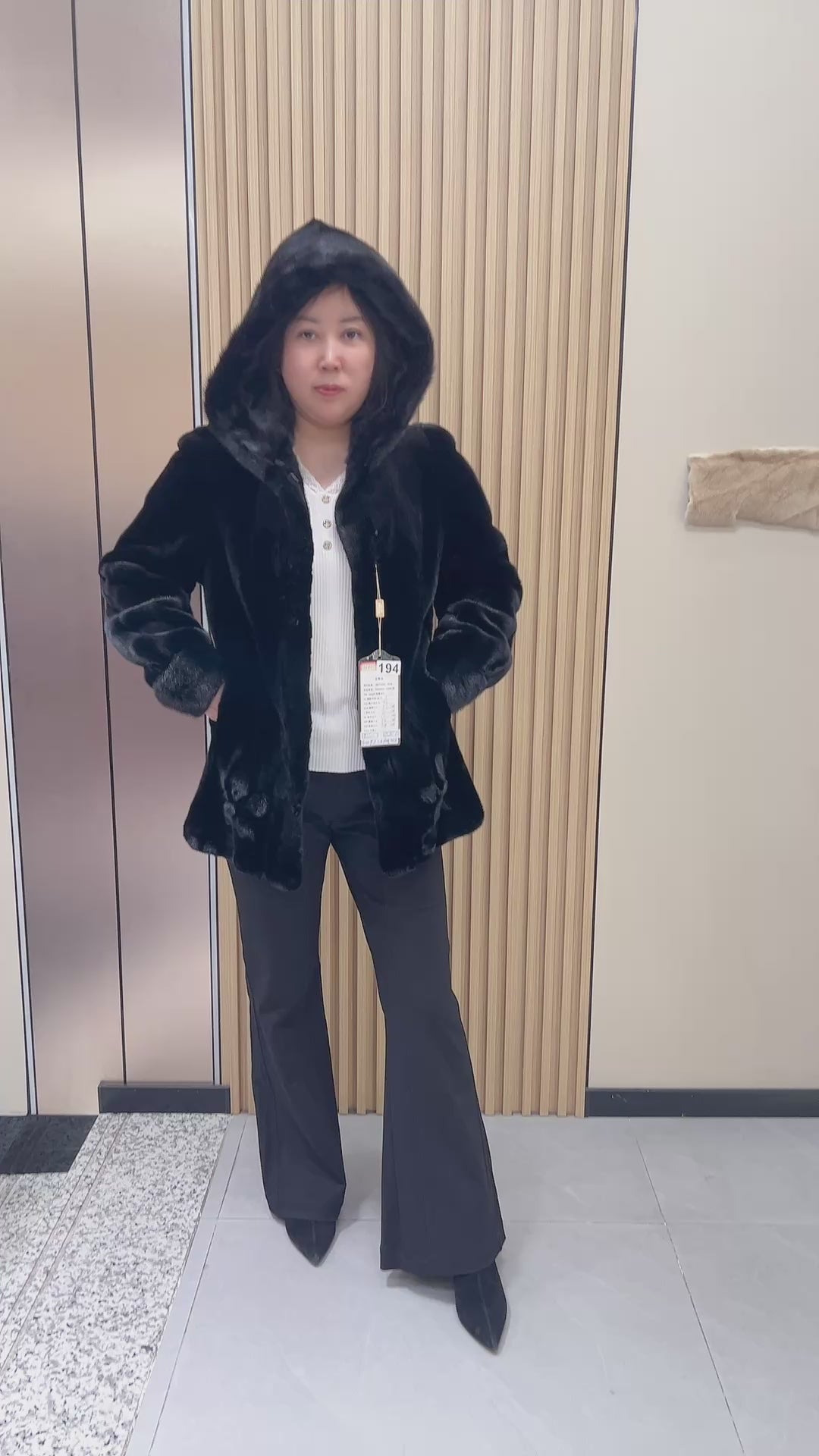 No. 194 black hooded mink fur coat, featuring a petal-shaped hem design.