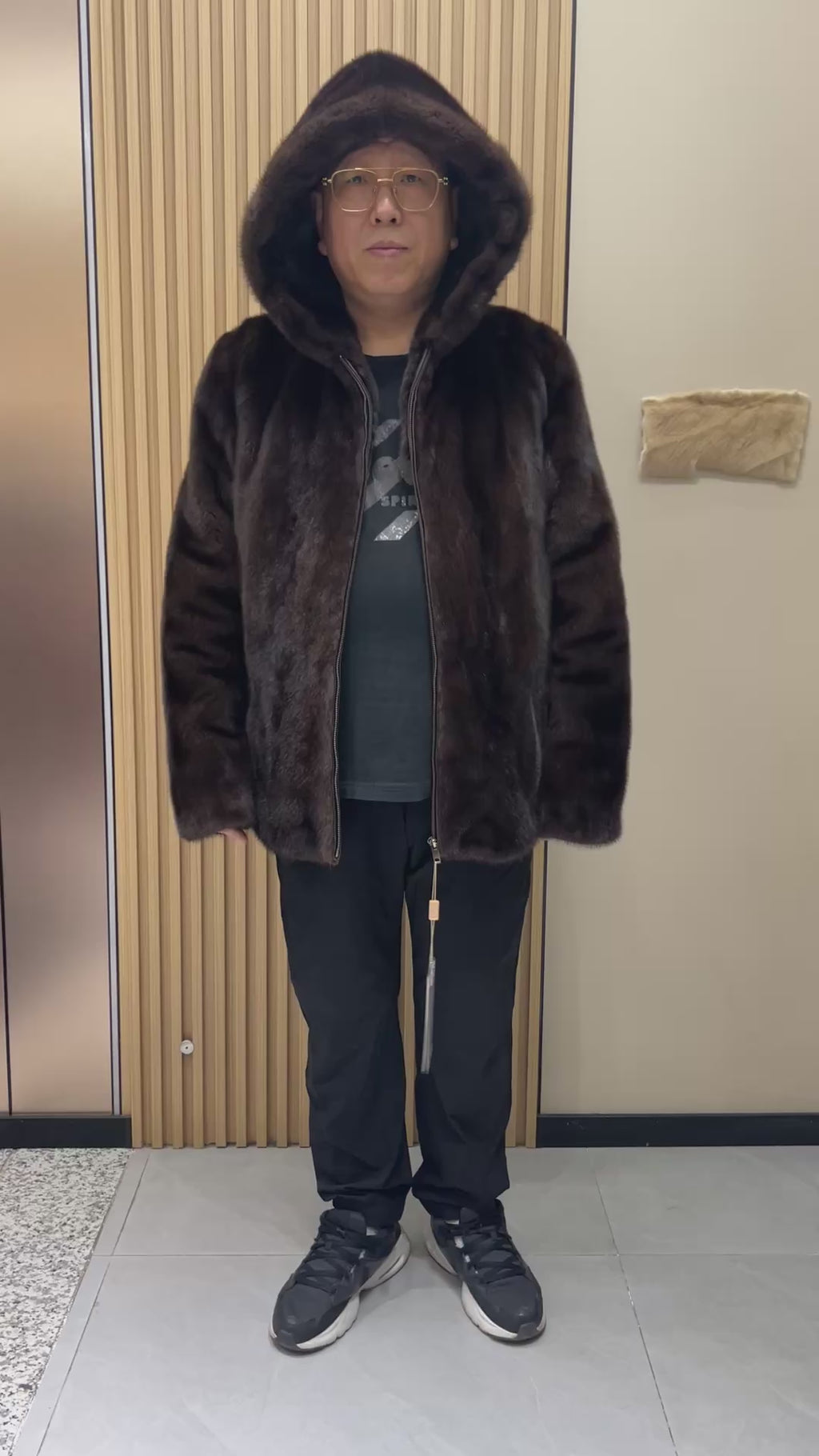 No. 126 Men's dark brown hooded mink coat with front zip closure.